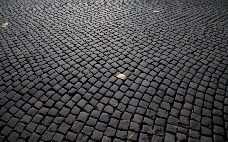 Detailed view of cobblestone pavement pattern in Katowice, Poland, highlighting its historic charm.