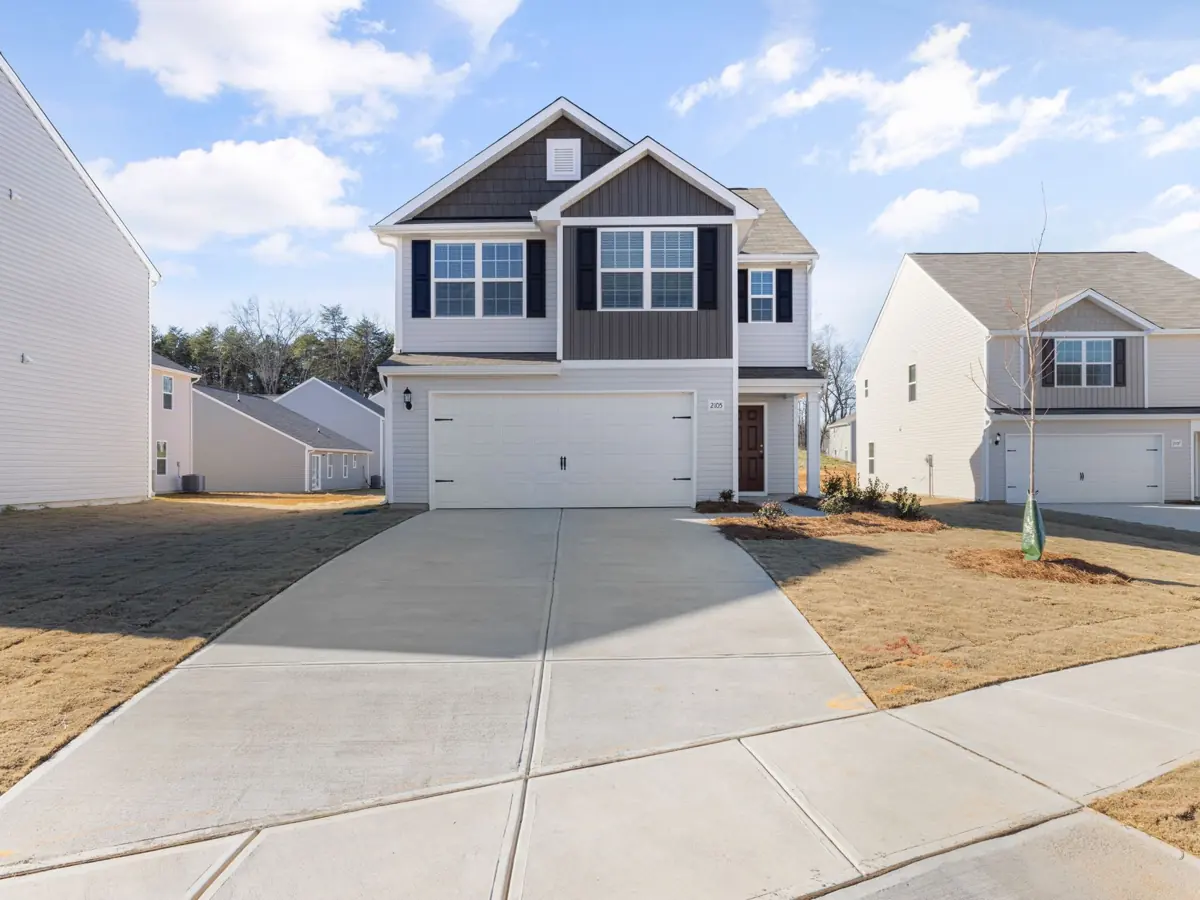 Spacious two-story house with a modern facade in a suburban neighborhood.