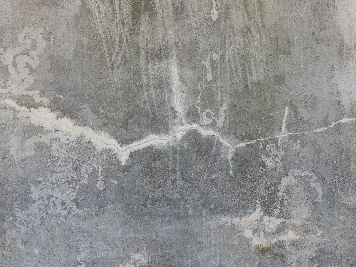 High-resolution image of a weathered and cracked concrete wall, perfect for texture background uses.