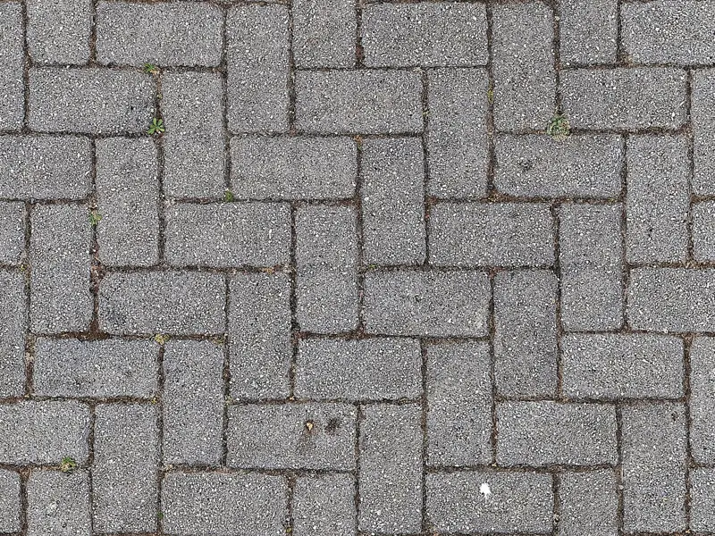 Close-up of interlocking gray brick pavement. Ideal for urban, texture, and construction themes.
