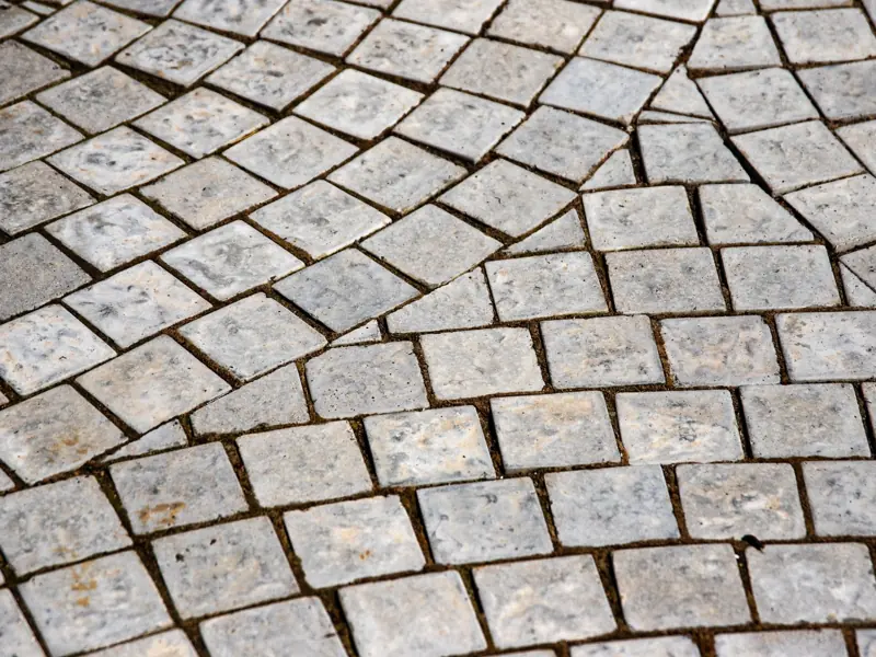 Close-up of an intricate stone pavement showcasing detailed texture and grey tones.
