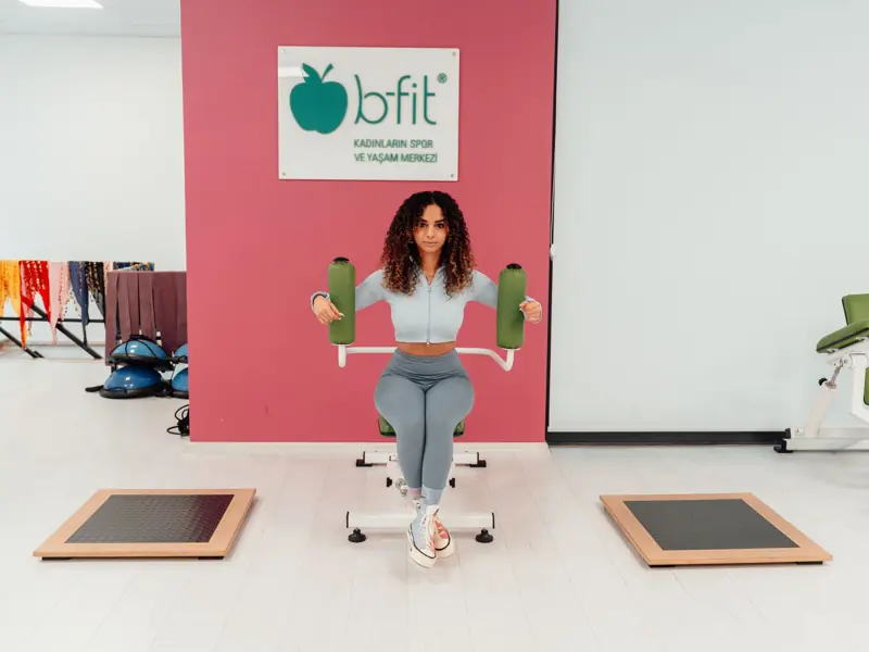 A woman exercising at B-Fit gym in Yalova, Türkiye, focused on fitness and health.