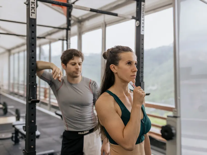 A fit couple engaged in gym exercises. Indoor workout with focus on fitness goals.
