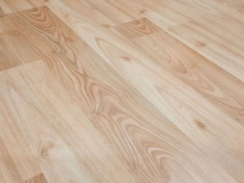 Smooth light brown wooden flooring with natural texture and patterns.