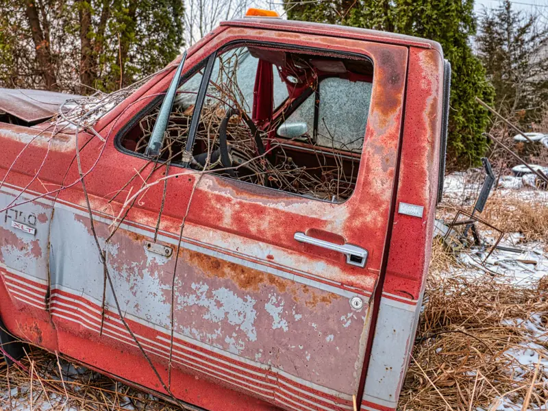 An old, rusty vintage truck abandoned in a snowy field in Wabasha, MN.