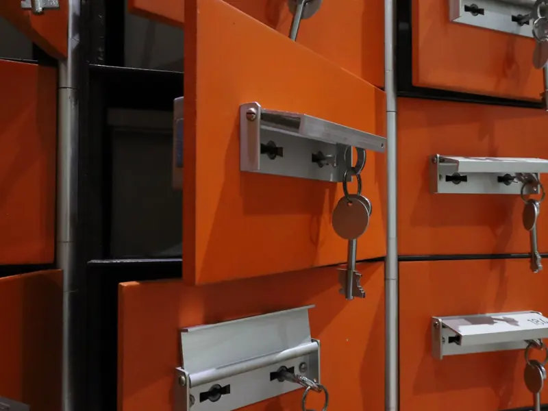 Orange lockers with metal keys highlighted in an indoor setting.
