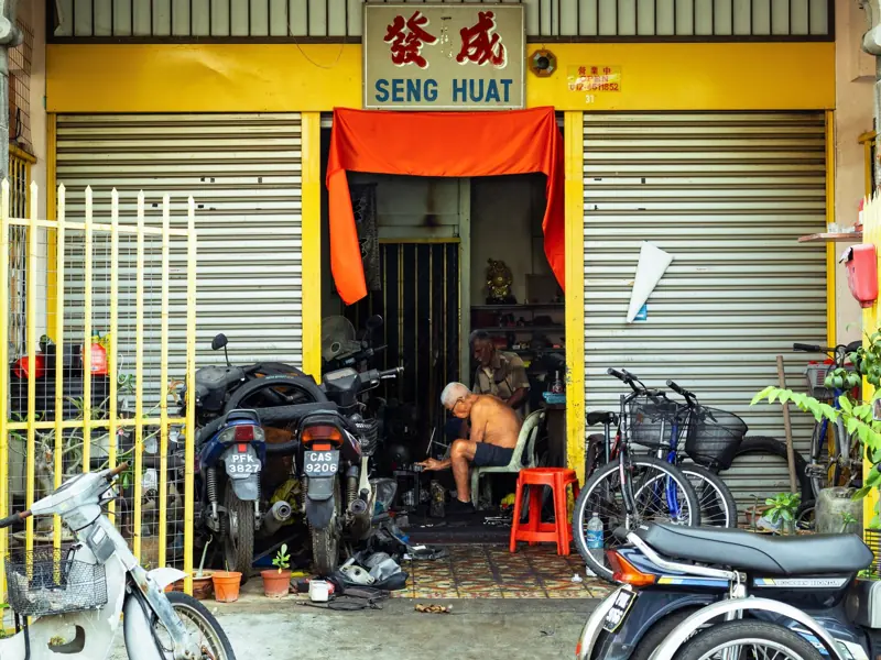 Traditional workshop with motorbikes and bicycles in Georgetown, Penang.