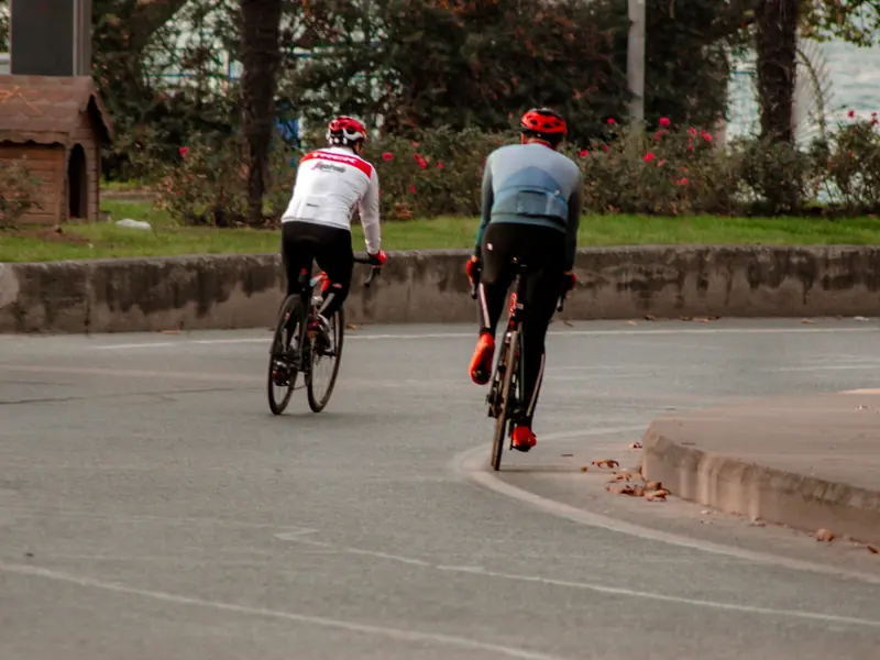 Two cyclists riding on an urban street in Istanbul, Turkey.