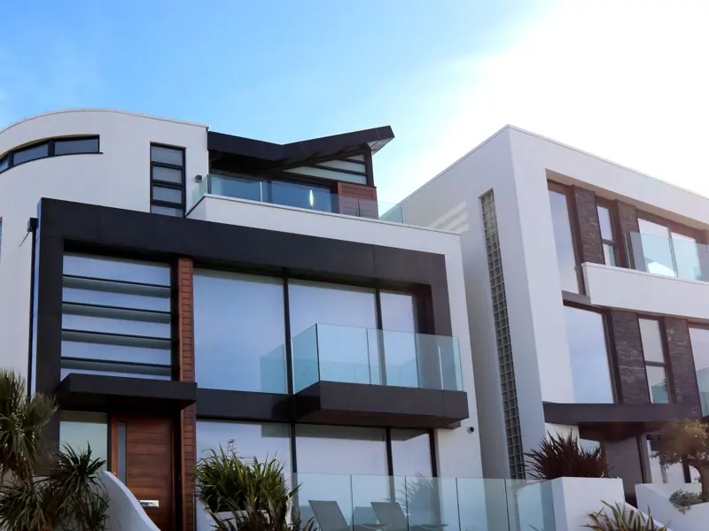 Contemporary luxury home with glass balconies in Poole, UK, showcasing modern architectural design.