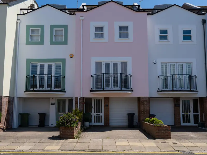 Charming terraced houses in Portsmouth, UK, featuring pastel colors and balconies.
