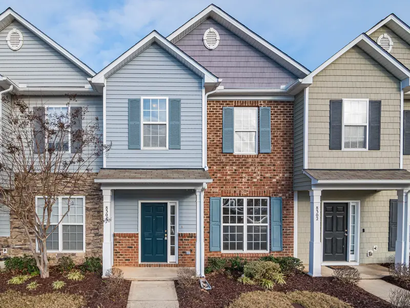 Elegant view of suburban townhouses showcasing diverse architectural styles.