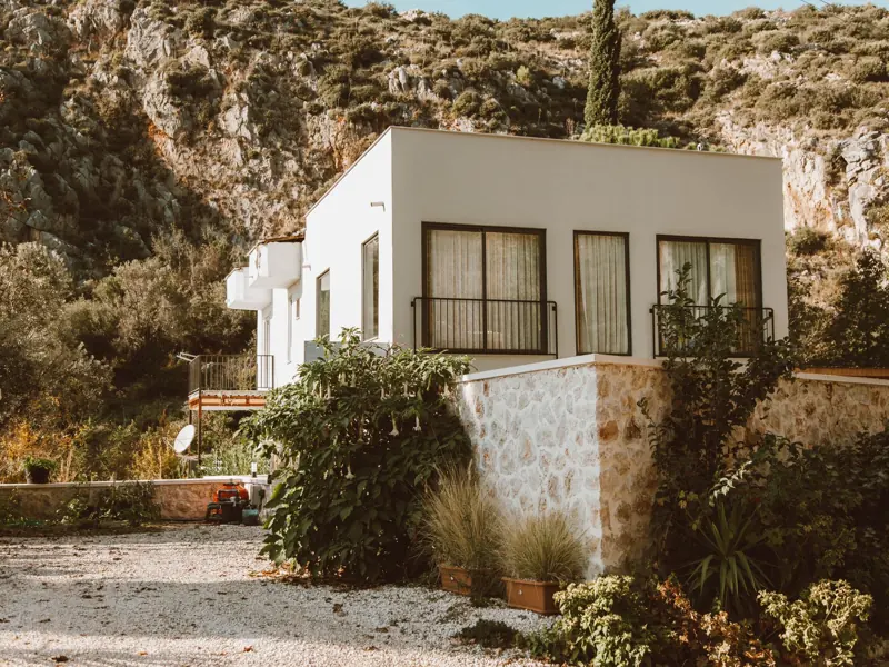 Contemporary house nestled in a sunlit rocky outdoor setting, perfect for architecture lovers.