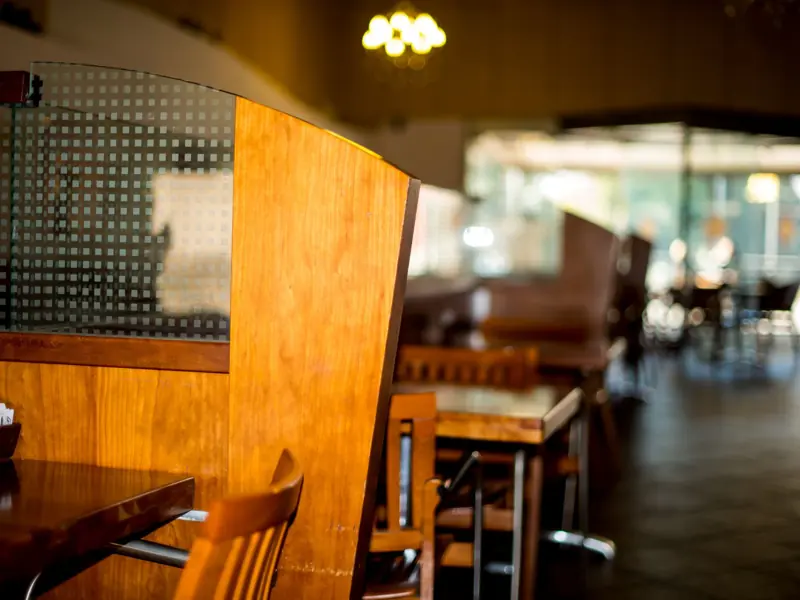 Warm, inviting restaurant interior featuring wooden tables and chairs. Perfect for dining settings.