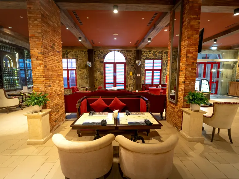 Elegant restaurant interior with stylish seating, warm lighting, and decorative elements.
