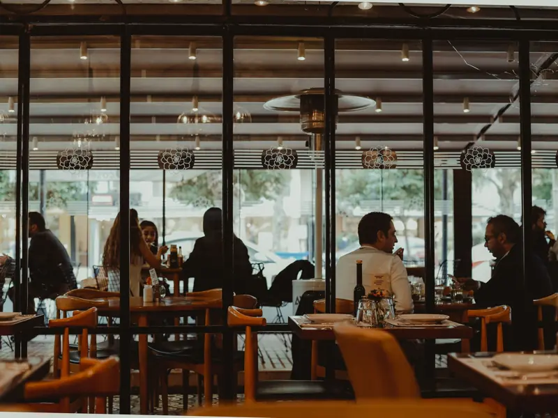 A bustling restaurant interior showcasing diners enjoying their meals in a cozy atmosphere.
