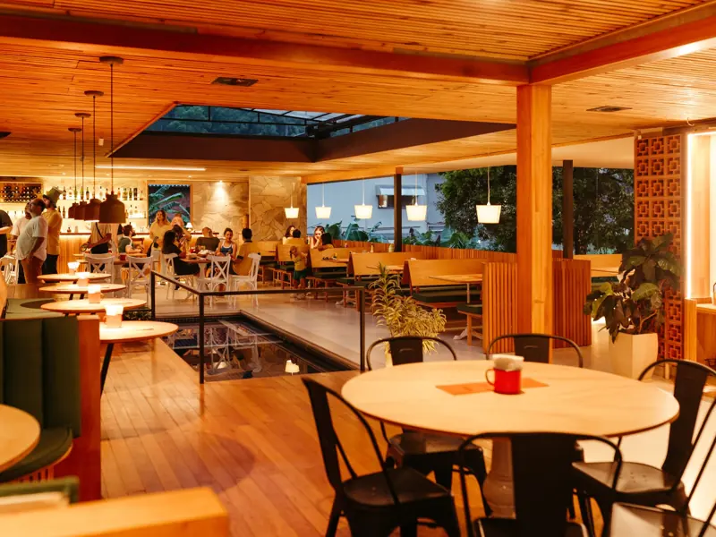 Warm and inviting restaurant interior with wooden decor and ambient lighting.