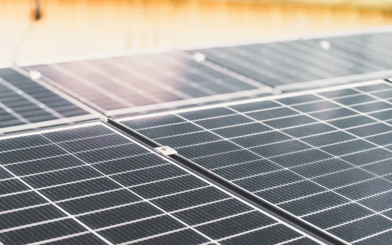 Detailed view of a rooftop solar panel array capturing sunlight for renewable energy production.