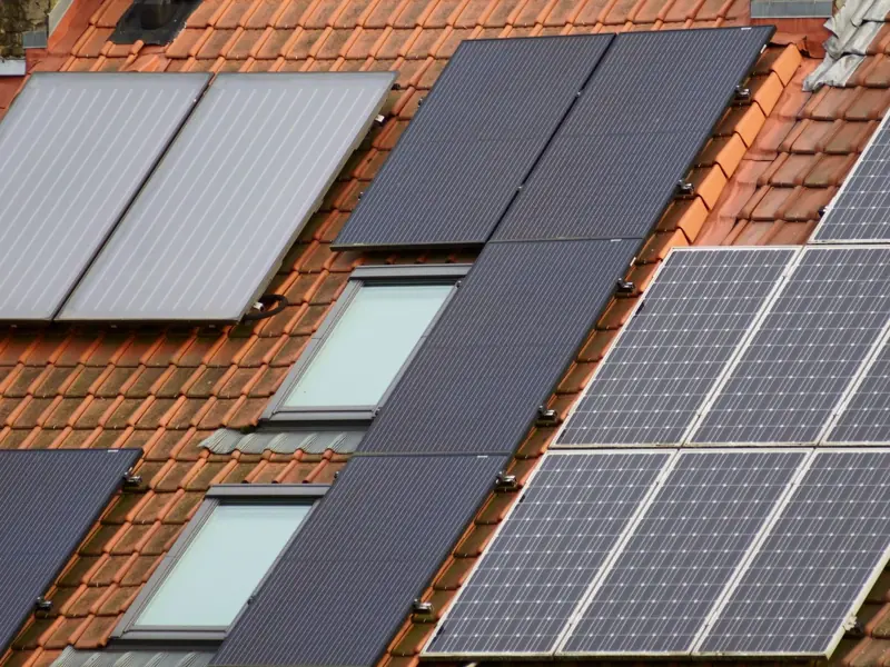 Close-up of solar panels on a tiled roof, showcasing sustainable energy solutions.
