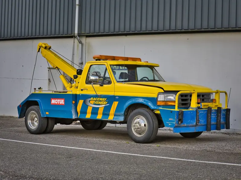 Yellow tow truck parked at Raceway Venray, showcasing automotive support in Ysselsteyn, Netherlands.